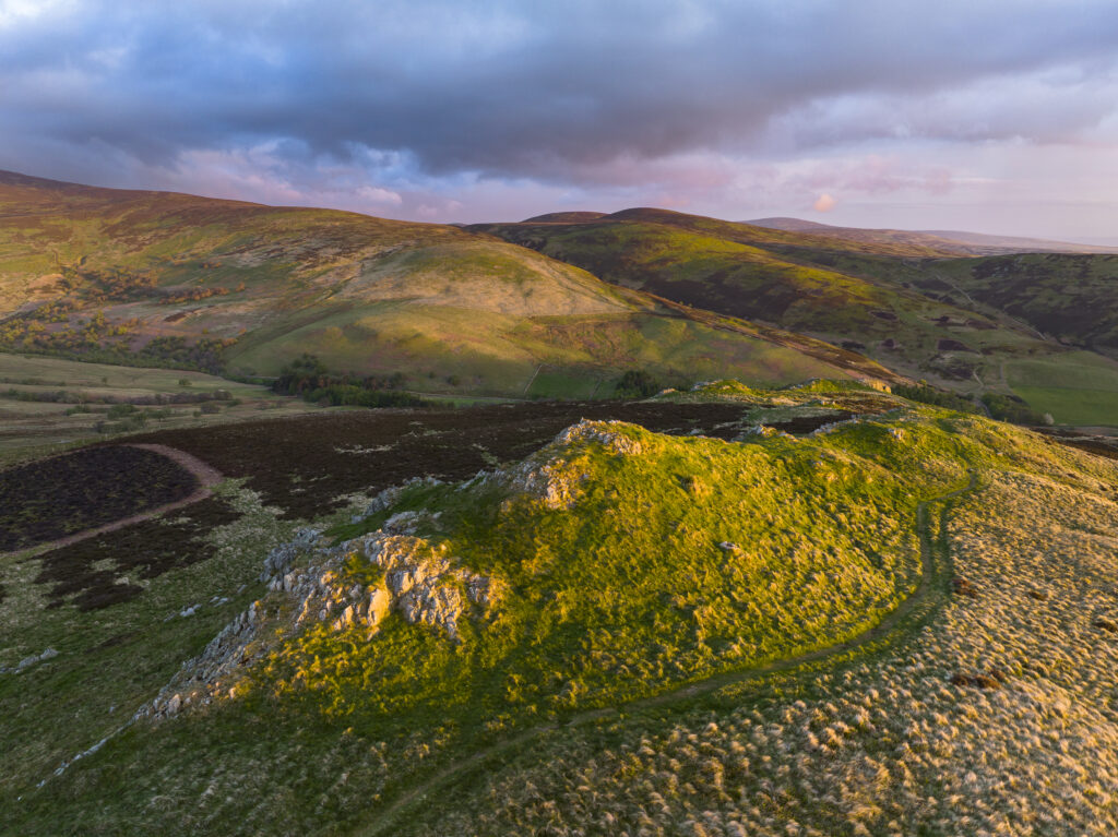England, Northumberland National Park, Harthope Valley. Dawn at Long Crags located above the Harthope Valley.