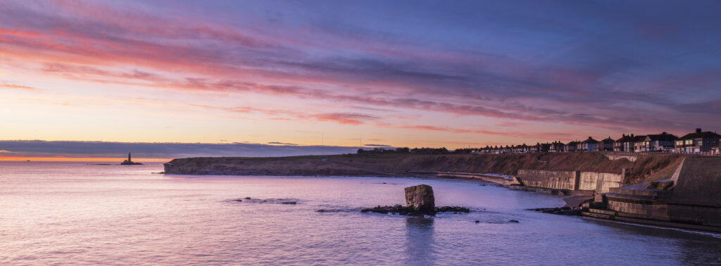 England, Northumberland, Seaton Sluice. Sunrise at Charlies Garden, a rock formation located in Collywell Bay, Seaton Sluice.