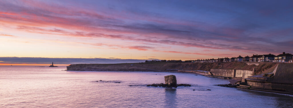 England, Northumberland, Seaton Sluice. Sunrise at Charlies Garden, a rock formation located in Collywell Bay, Seaton Sluice.
