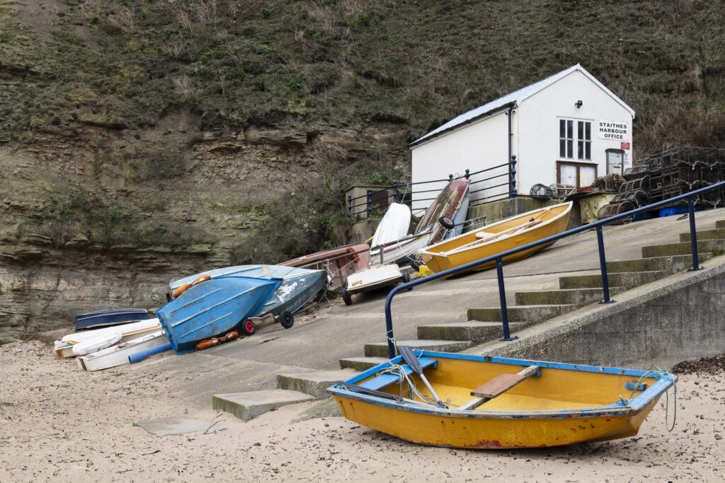 England, North Yorkshire, North York Moors National Park. Early morning light at Staithes Harbour Office, located near the coastal village in the North York Moors National Park.