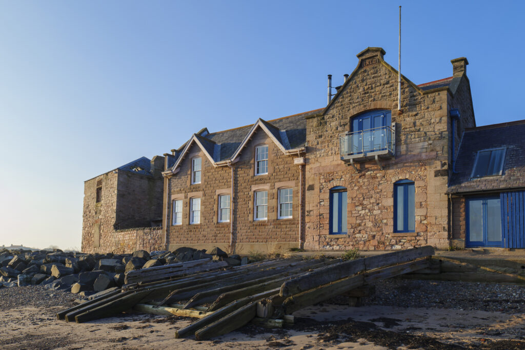 England, Northumberland, Berwick Upon Tweed. The Old Lifeboat House near the quayside and the mouth of the tweed.