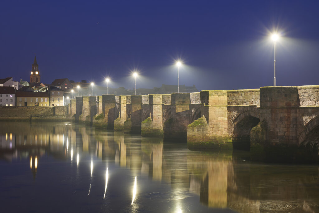 England, Northumberland, Berwick Upon Tweed. Evening scene of Berwick Old Bridge Bridge spanning the River Tweed.