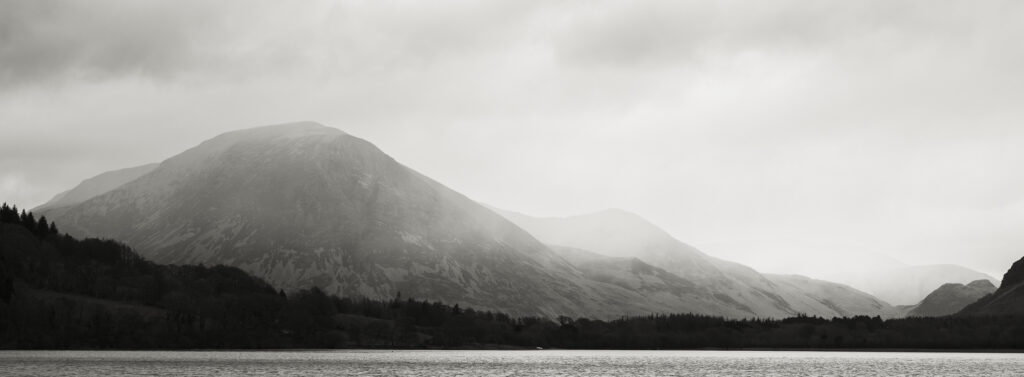 England, Cumbria, Lake District National Park. Rain clouds engulf the mountain peaks surrounding Loweswater.