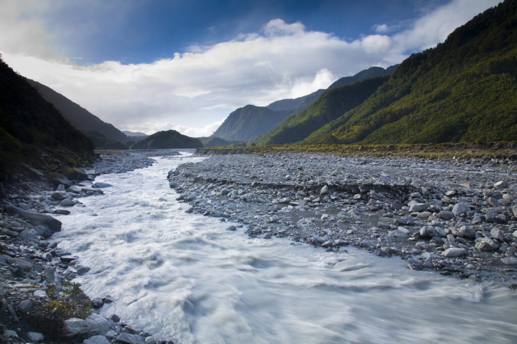 NEW ZEALAND, Westland, Westland National Park. Glacial valley and river downstream of the Franz Josef Glacier.