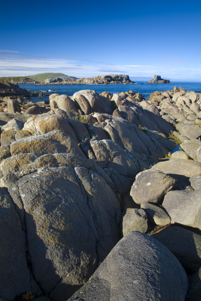 New Zealand, Southland, Cosy Nook. Cosy Nook, a picturesque craggy cove that shelters several fishing boats & holiday cribs.