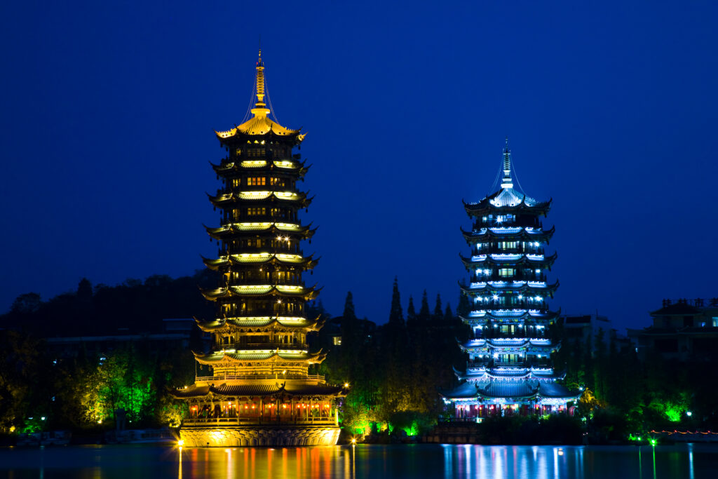 China, Guangxi Zhuang Autonomous Region, Guilin City. Illuminated Pagodas at dusk, located near Banyan Lake in downtown Guilin.