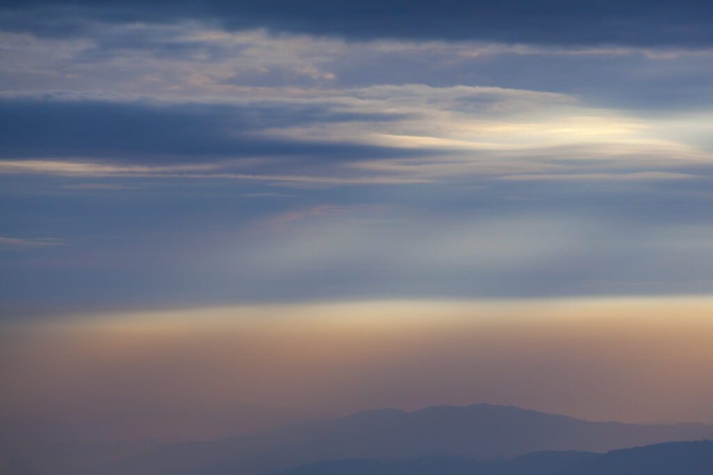 England, Cumbria, Lake District National Park. Mountain fog covers the hills of the western Lake District viewed from the Eastern Fells.