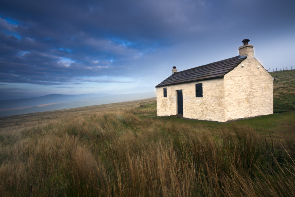 England, Cumbria, North Pennines. A small cottage located within the barren landscape of Hartside Pass near Alston within the North Pennines Area of Outstanding Natural Beauty (AONB)