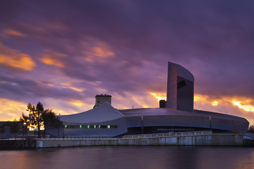 England, Greater Manchester, Salford Quays. Sunset behind the Imperial War Museum North, located on the Salford Quays in the city of Salford near Manchester Old Trafford.