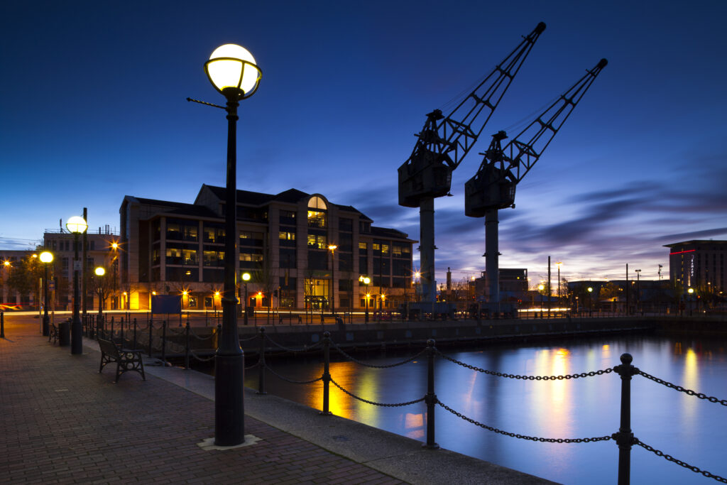 England, Greater Manchester, Salford Quays. Cranes overlooking Ontario Basin part of the recently redeveloped Salford Quays in Greater Manchester.