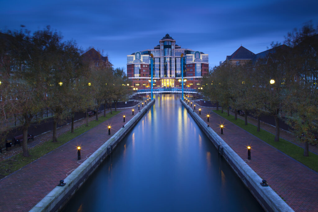 England, Greater Manchester, Salford Quays. Victoria Harbour building beyond Mariner's Canal footbridge on the Manchester Ship Canal located in Salford.