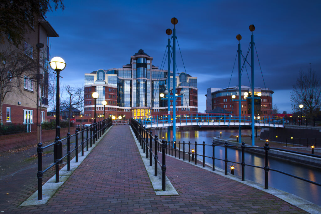 England, Greater Manchester, Salford Quays. Victoria Harbour building beyond Mariner's Canal footbridge on the Manchester Ship Canal located in Salford.
