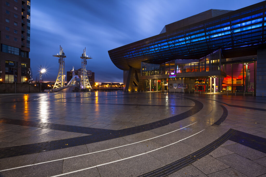 England, Greater Manchester, Salford Quays. The Lowry Centre at dusk looking towards the Lowry Bridge, located on the Salford Quays in the city of Salford near Manchester Old Trafford.