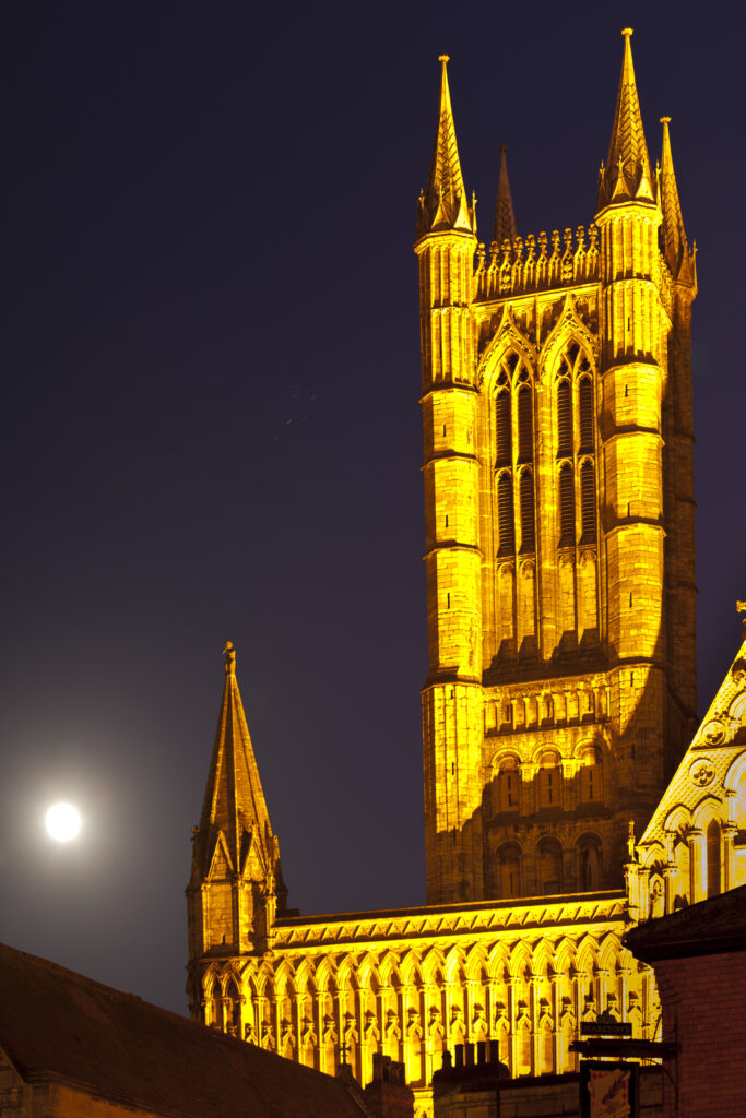 England, Lincolnshire, Lincoln. Full moon behind Lincoln Cathedral in the historic UK city of Lincoln.