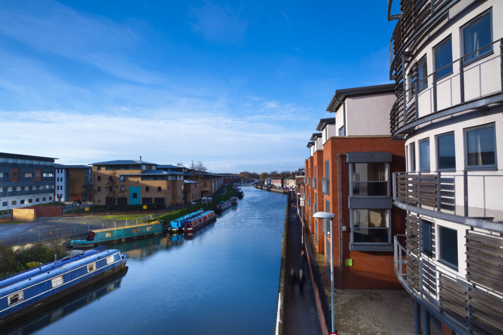 England, Lincolnshire, Lincoln. Canal Barges and University Student accommodation near the Brayford Pool and Brayford Quays in Lincoln.