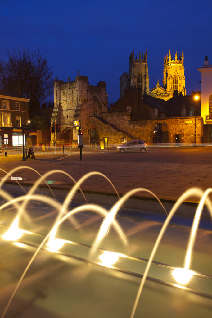 England, North Yorkshire, York City. The west front of the york minster cathedral ovelooking the city walls, viewed from fountains in the city art gallery.