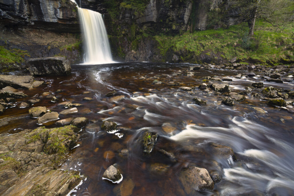 England, North Yorkshire, Ingleton. The fast flowing waters of the Thornton Force waterfall near Ingleton.