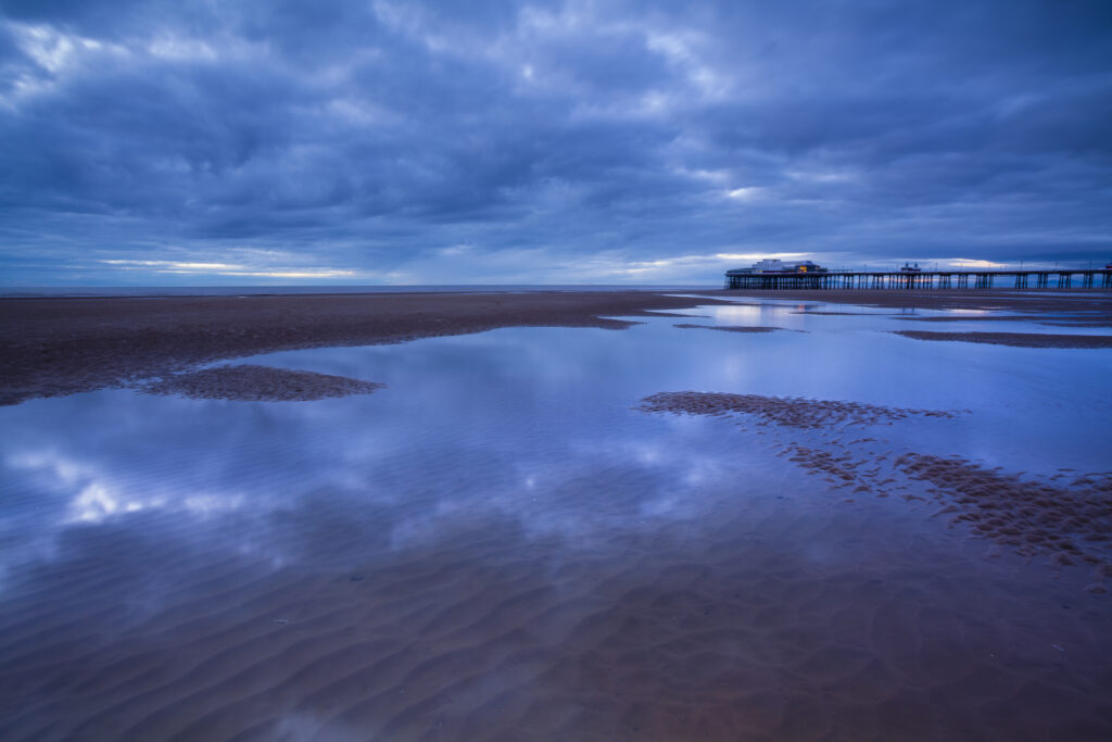 England, Lancashire, Blackpool. Looking towards the North Pier at dusk, a famous landmark of the popular seaside resort.