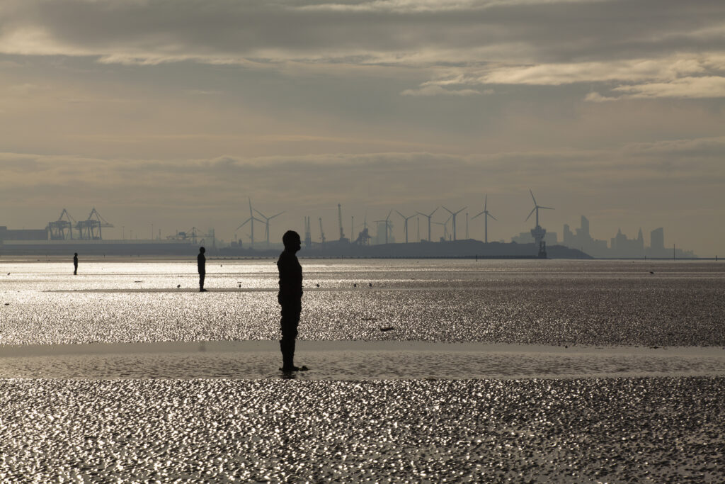 England, Merseyside, Antony Gormley Another Place. Antony Gormley sculptures at Crosby Beach near Liverpool in England.