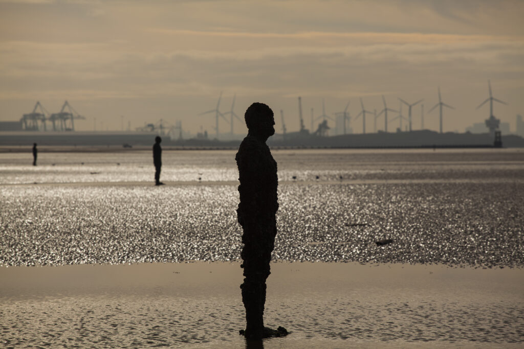 England, Merseyside, Antony Gormley Another Place. Antony Gormley sculptures at Crosby Beach near Liverpool in England.