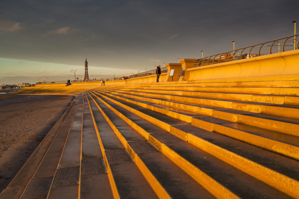 England, Lancashire, Blackpool. Blackpool Seafront Steps and Sea Defenses looking towards the Blackpool Tower.