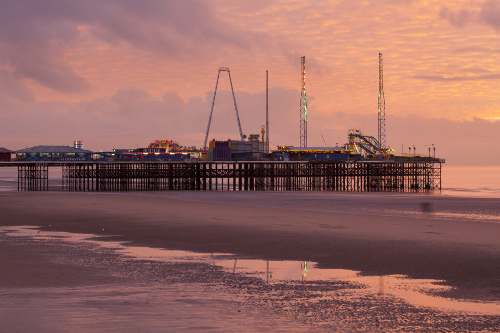 England, Lancashire, Blackpool. Blackpool South Pier at sunset.
