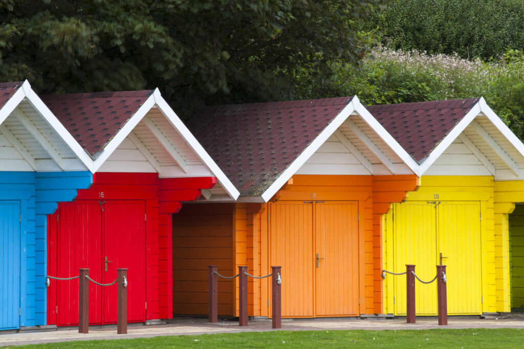England, North Yorkshire, Scarborough. Colourful beach huts located on Scarborough South Bay.