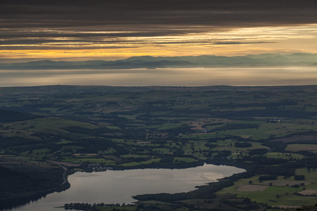 England, Cumbria, Lake District National Park. View from near the summit of Skiddaw, looking towards Bassenthwaite Lake with the Solway Firth and Scottish Uplands in the distance.