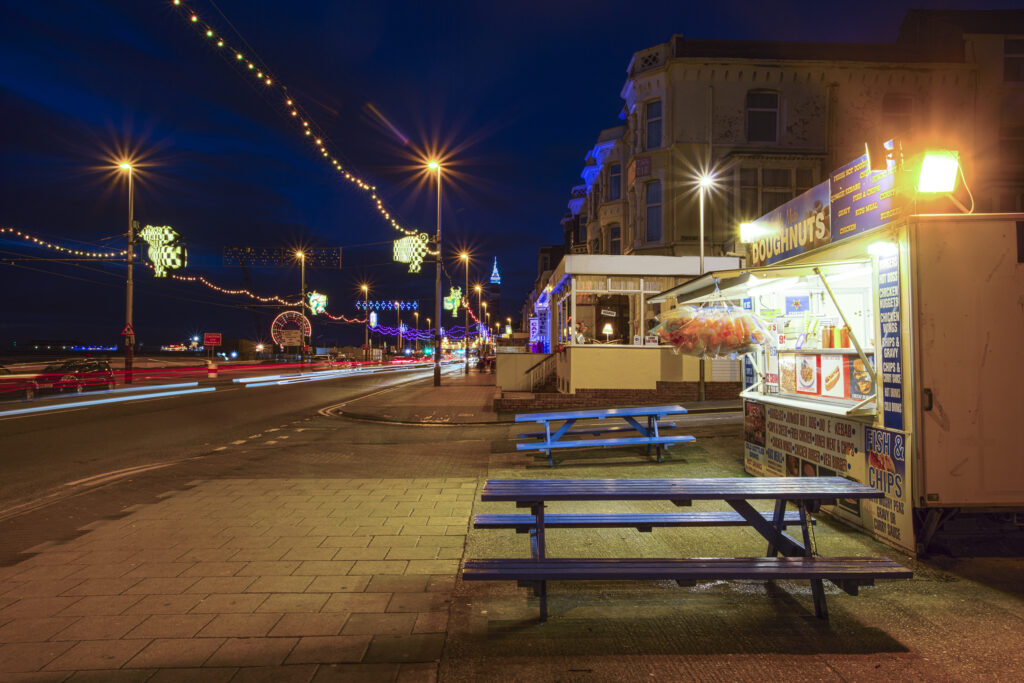 England, Lancashire, Blackpool. Doughnut stall on the Blackpool seafront during the illuminations.