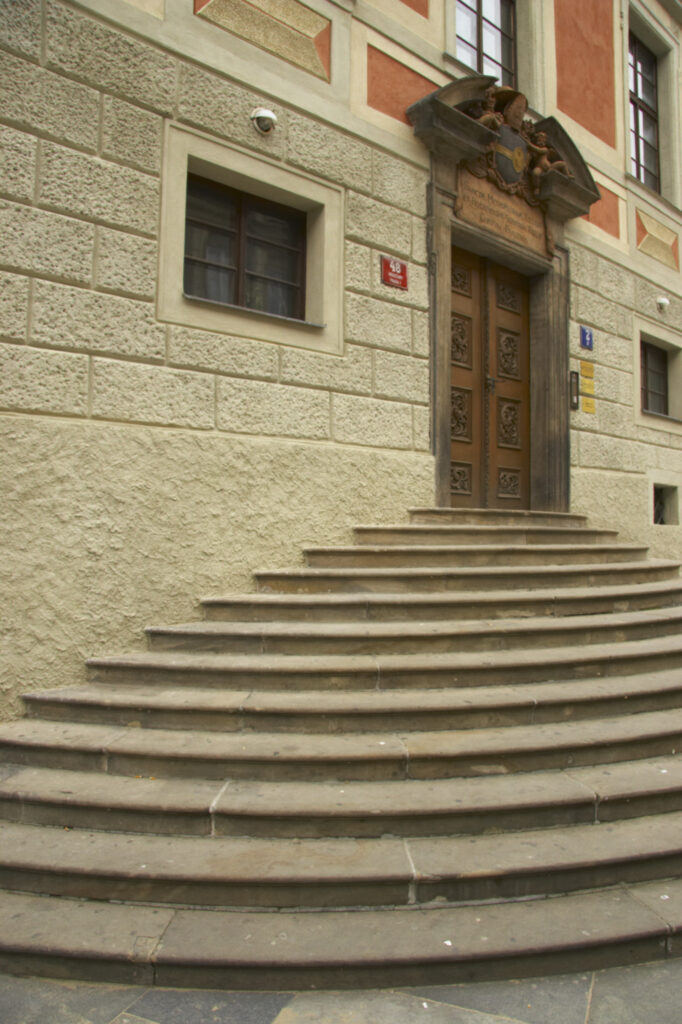 Czech Republic, Prague, Prague Castle. A rustic door and steps on a building forming part of Prague Castle in the city of Prague