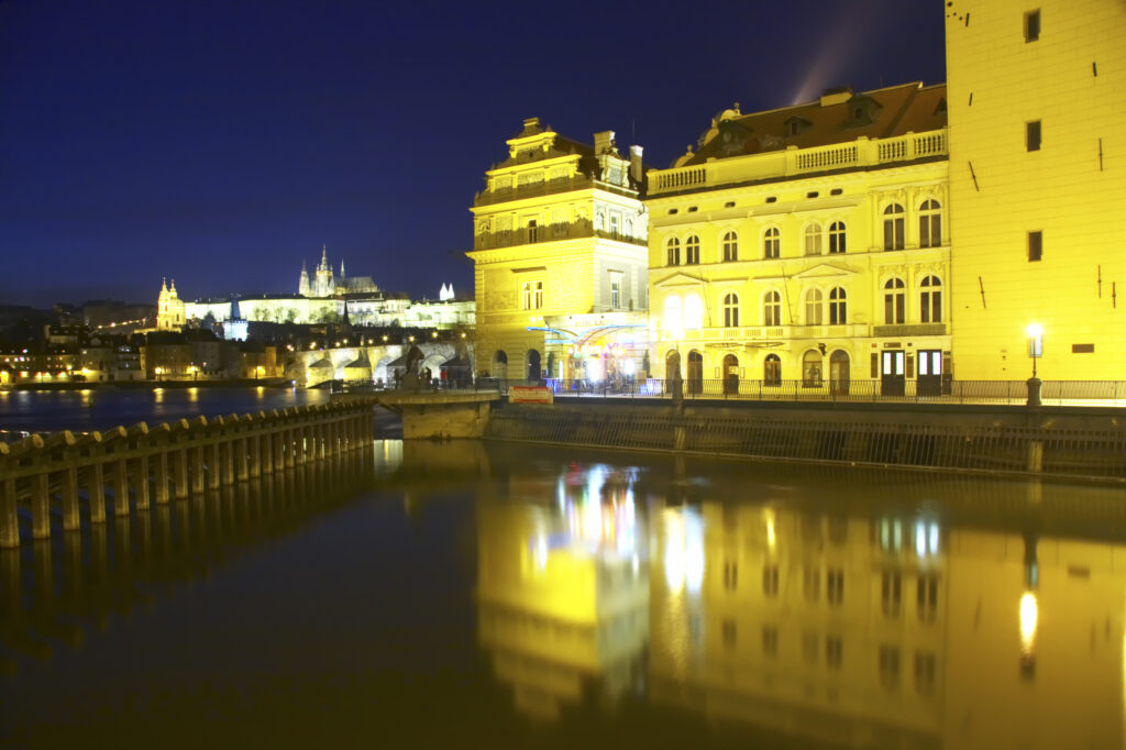 Czech Republic, Prague, Prague City. Prague city at dusk with Prague Castle reflected in the still waters of the Vltave River.