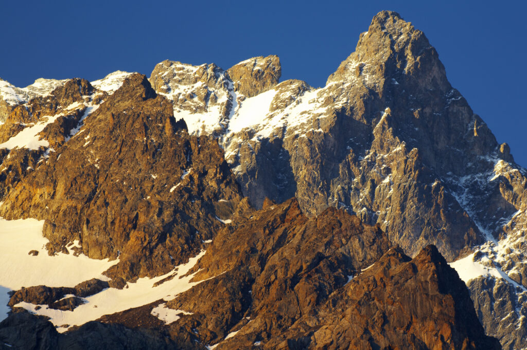 France, Rhône-Alpes, The Ecrins National Park. Morning light illuminates the peak of La Meije, within the Ecrins National Park near the village of La Grave.