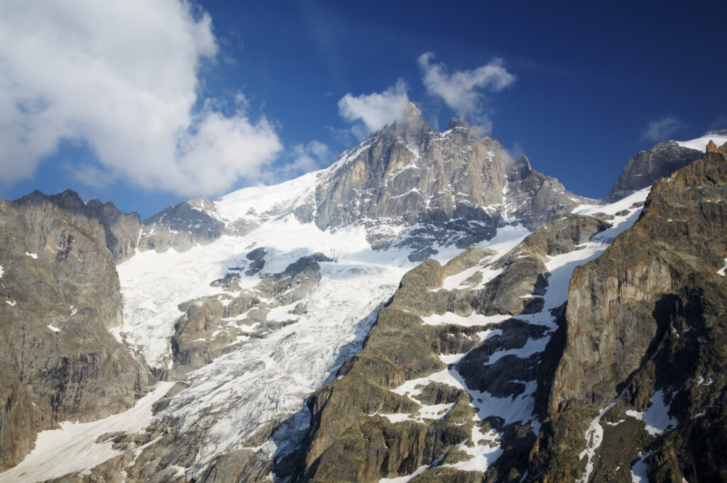France, Rhône-Alpes, The Ecrins National Park. Evening light bathes the majestic peak of La Meije and surrounding glaciers.