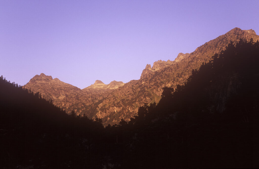 FRANCE, Midi Pyrenees, Pyrenees National Park. Early morning light illuminates the peaks of the park found by Pont d Espagne