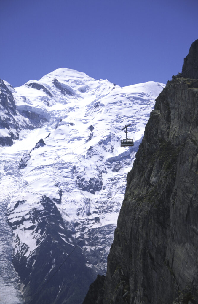 France, French Alps, Mont Blanc. A cable car drawfed by the Massif du Mont Blanc.