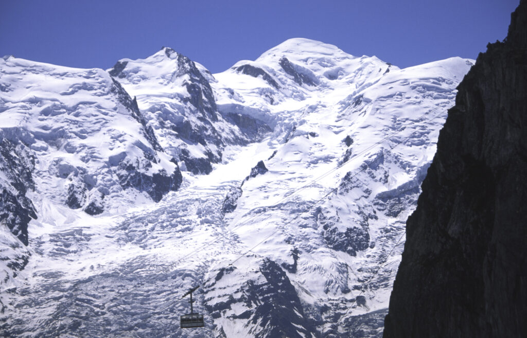 France, French Alps, Mont Blanc. A cable car drawfed by the Massif du Mont Blanc.