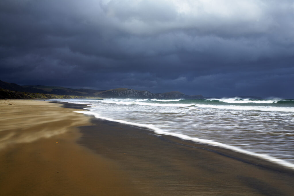 New Zealand, Southland, The Catlins. A storm brews over Tahakopa Bay near the town of Papatowai.