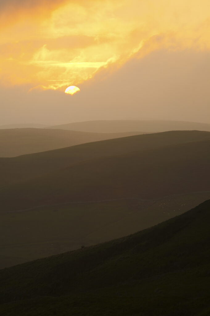 England, Northumberland, Northumberland National Park. Sunset over the rolling Cheviot Hills, viewed from the Border Coutry Ride route near Murder Cleugh.
