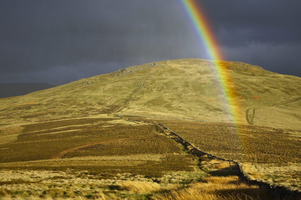 England, Northumberland, The Pennine Way. A rainbow above the Schil on the England / Scottish Border.