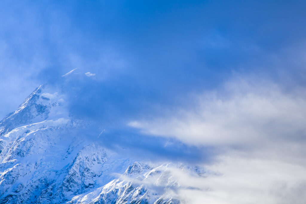 New Zealand, Canterbury, Mt Cook National Park. Storm clouds gather around the peak of the mighty Mt Cook (known to the Maori as Aoraki) the highest peak in Australasia at 3755M.