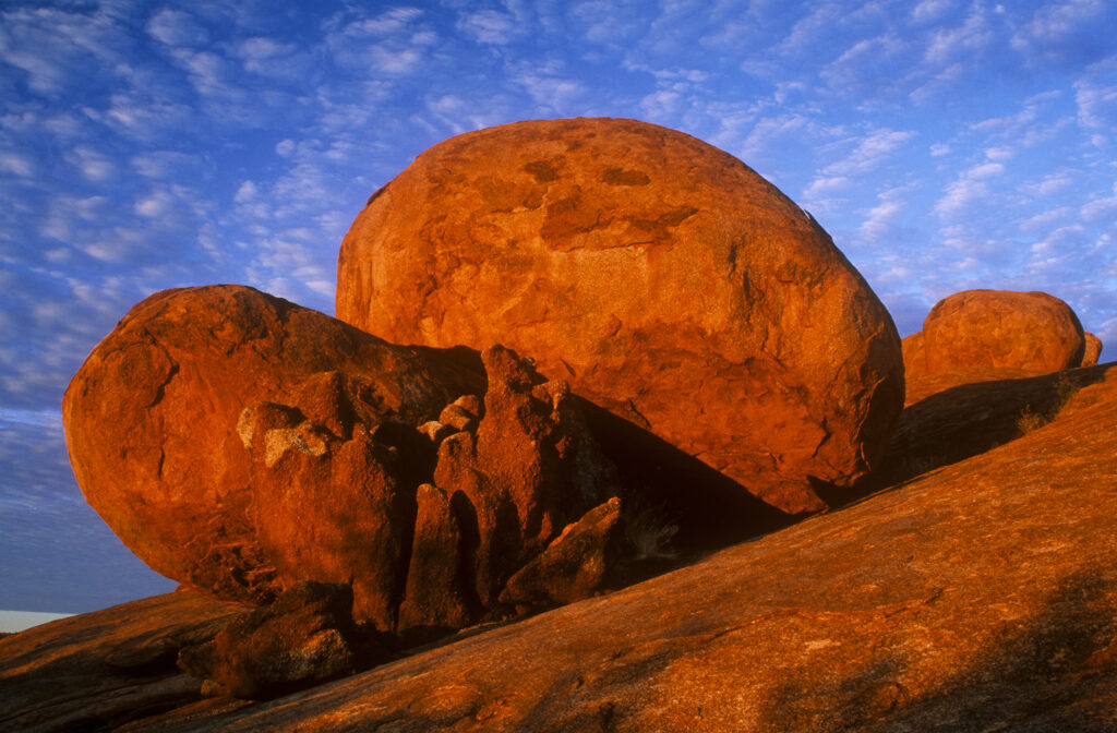Australia, Northern Territory, Devils Marbles. Evening light illuminates the boulders of this popular tourist destination
