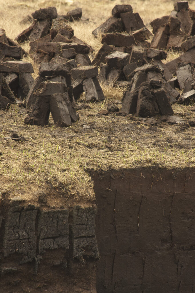 Scotland, Scottish Highlands and Islands, The Isle of Skye. Peat piles left to dry next to actual site of cutting.