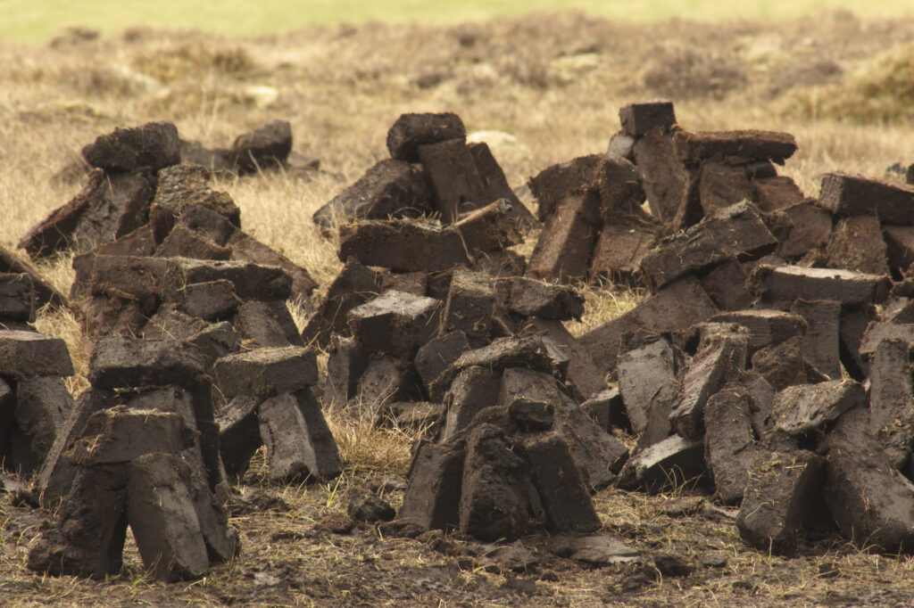Scotland, Scottish Highlands and Islands, The Isle of Skye. Peat piles left to dry next to actual site of cutting.