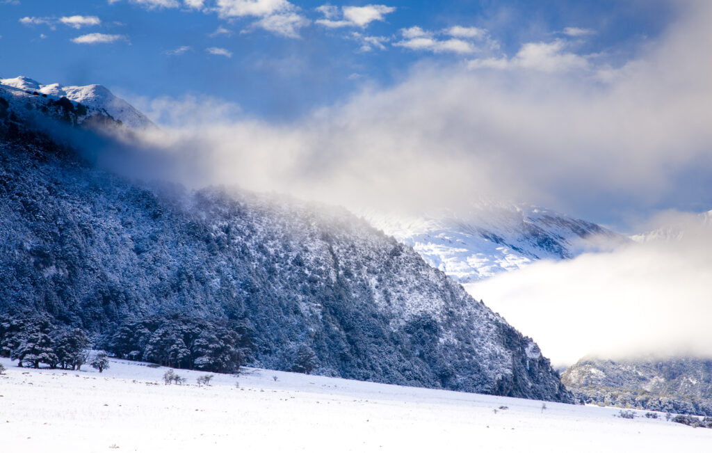 New Zealand, Otago, Mt Aspiring National Park. Clearing clouds from a snow and frost covered West Matukituki Valley.