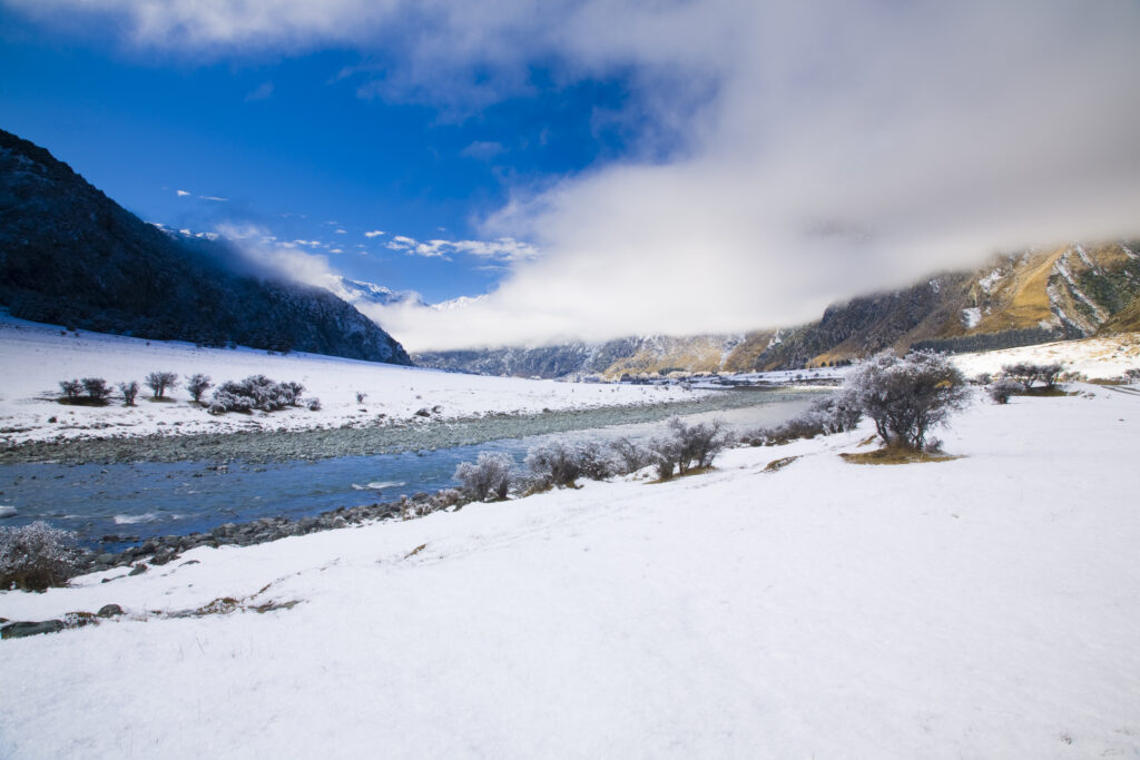 New Zealand, Otago, Mt Aspiring National Park. Clearing clouds from a snow and frost covered West Matukituki Valley.