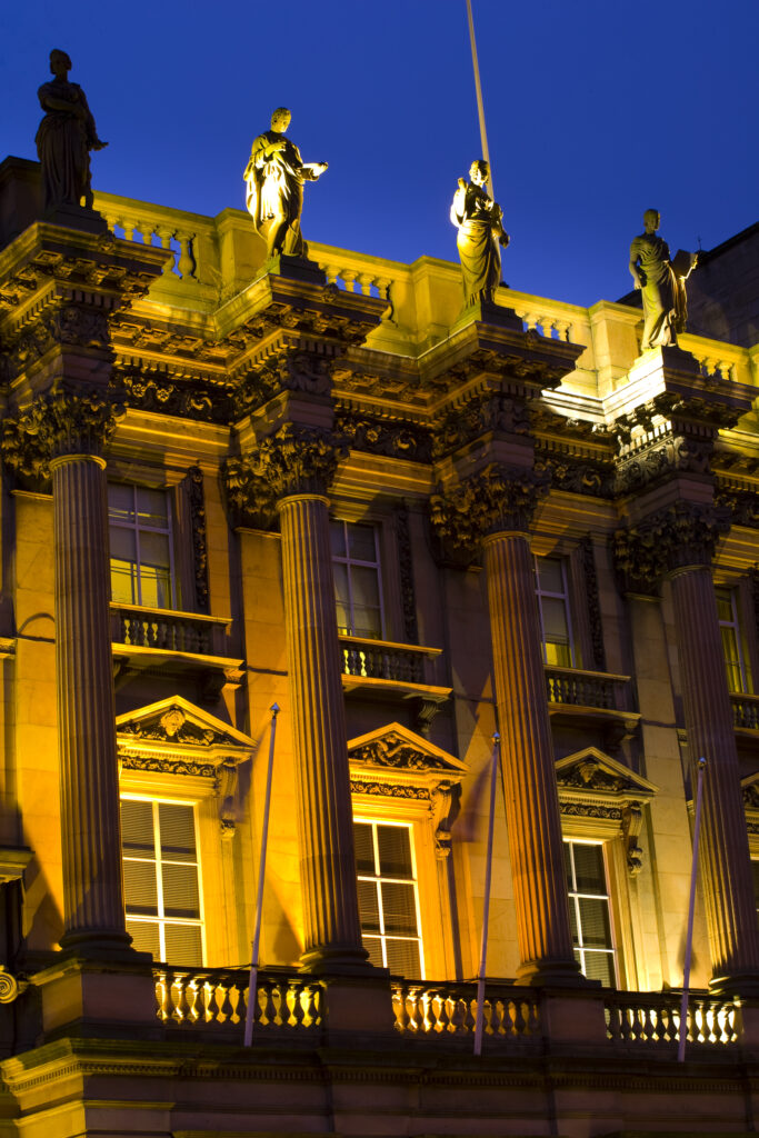 Scotland, Edinburgh, St Andrew's Square. Statutes situated on a flood lit building in St Andrew's Square.