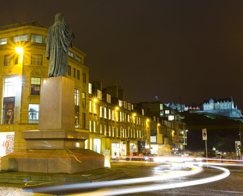 Scotland, Edinburgh, George Street. Statue of Dr Thomas Chalmers, a noted scholar and mathematician, looking down Castle Street towards Castle Hill.