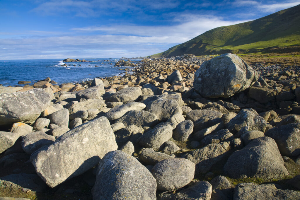 New Zealand, Southland, Cosy Nook. Cosy Nook, a picturesque craggy cove that shelters several fishing boats & holiday cribs.
