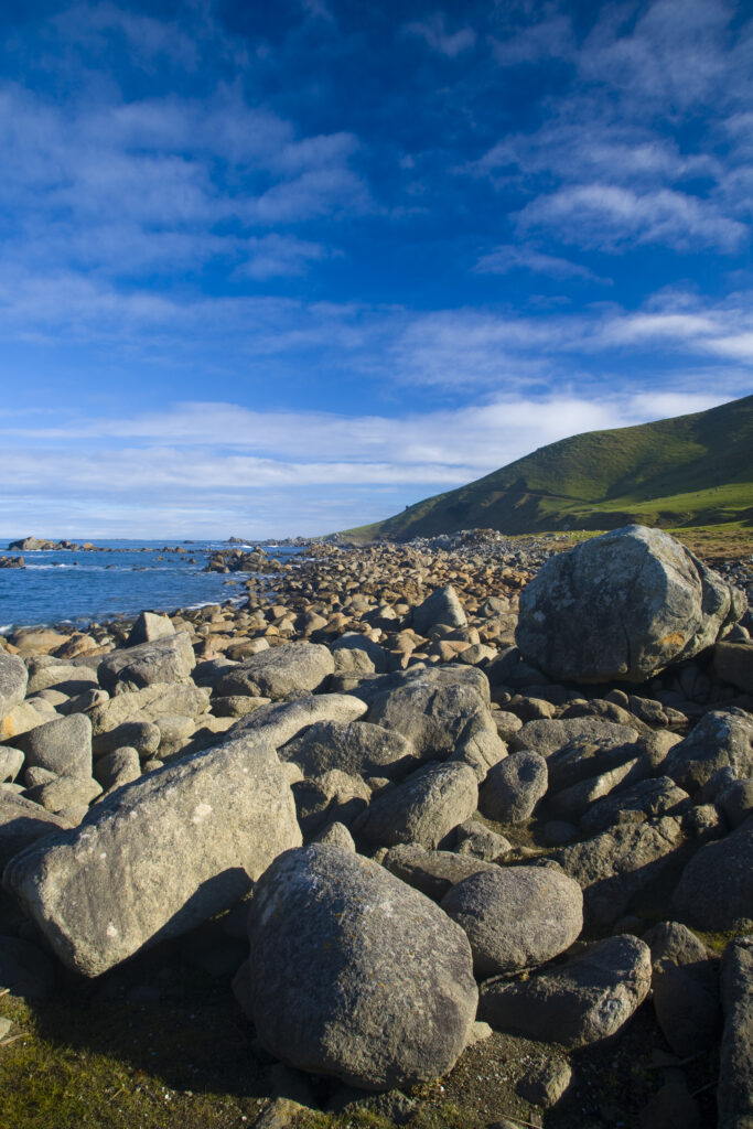 New Zealand, Southland, Cosy Nook. Cosy Nook, a picturesque craggy cove that shelters several fishing boats & holiday cribs.