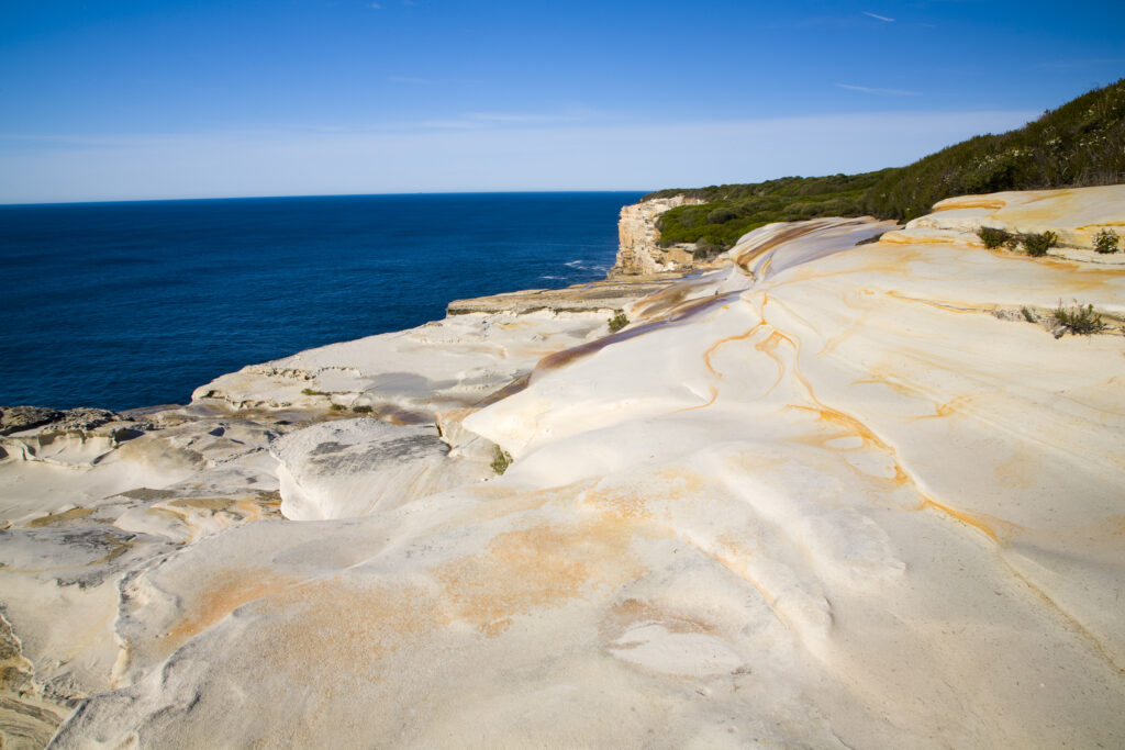 Australia, New South Wales, Royal National Park. Sandstone cliifs overlooking the Pacific Ocean viewed from the Royal National Park Coastal Track.